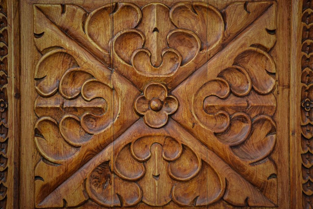 Close-up of a detailed wooden carving showcasing decorative patterns and craftsmanship.